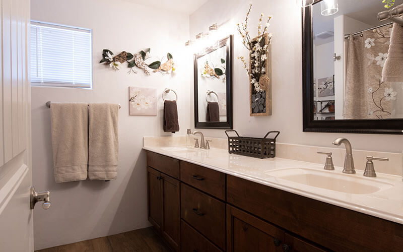 remodeled bathroom with dual vanity sinks