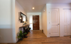 hallway renovation with hardwood floors and white walls