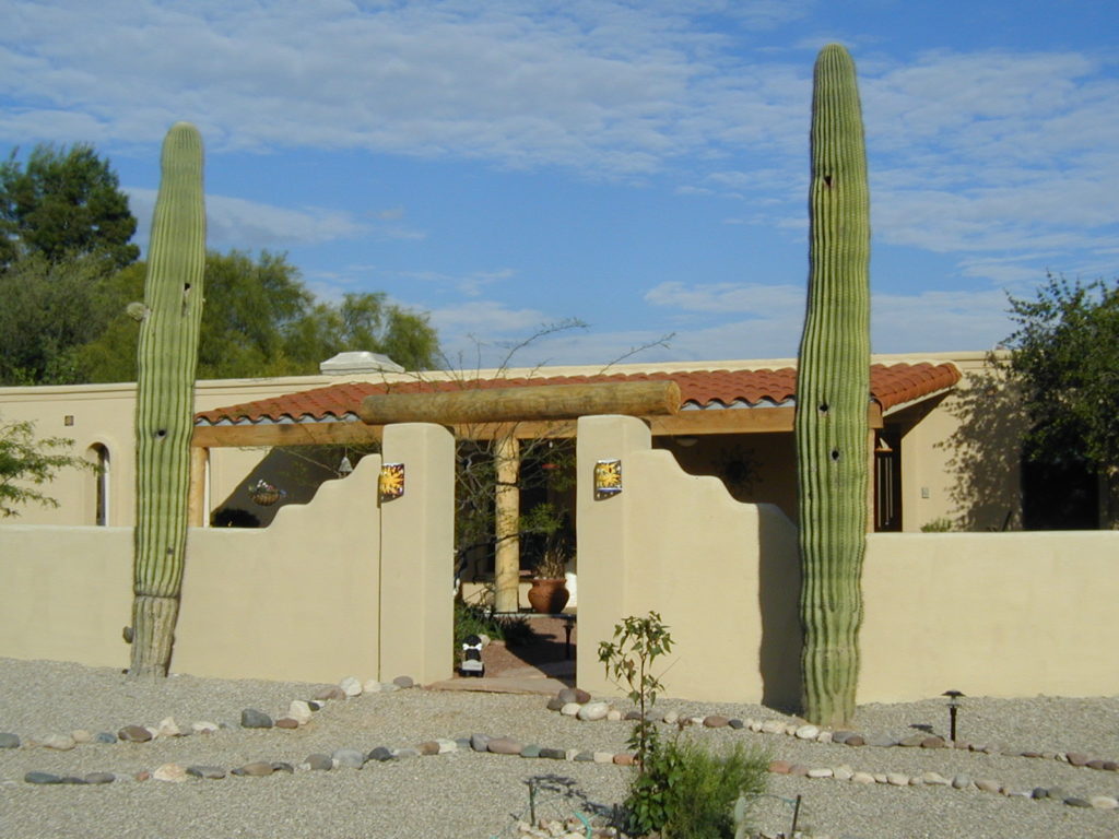 front of Tucson house with walled yard and large cactuses