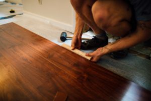 Worker installing laminate flooring